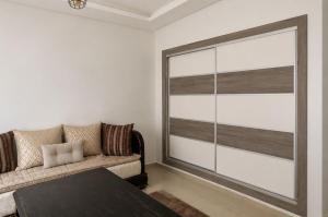 a living room with a couch and a large window at Parc app in Mohammedia
