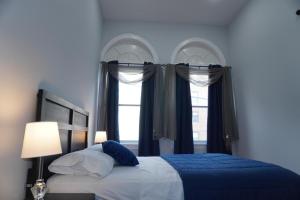 a bedroom with a bed and two windows at New York view 37 in West New York