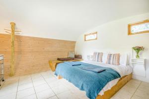 a bedroom with a bed and a wooden wall at 1 Bed in Bude oc-s34857 in Bude