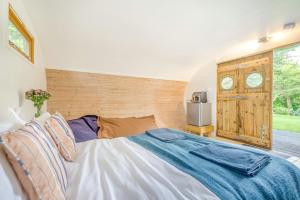 a bedroom with a large bed and a window at 1 Bed in Bude oc-s34857 in Bude