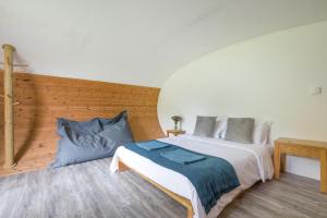 a bedroom with a large bed and a wooden wall at 1 Bed in Bude oc-s34855 in Bude