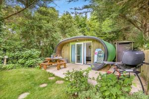 a small circular house with a picnic table and a tv at 1 Bed in Bude oc-s34858 in Bude