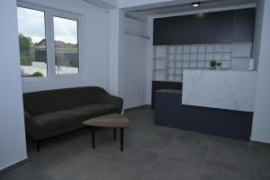 a living room with a couch and a table at DION Hotel & Restaurant in Kumanovo