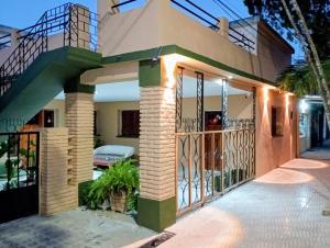 a house with a gate and a garage at Amoite hotel boutique in Nuestra Señora del Rosario de Caa Catí
