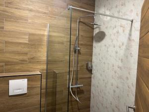 a bathroom with a shower with a glass door at DION Hotel & Restaurant in Kumanovo +25 photos