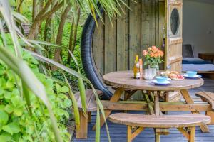 a wooden table and chairs on a wooden deck at 1 Bed in Bude oc-s34853 in Bude