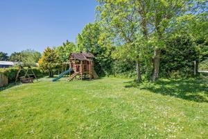 a playground with a slide in a yard at 1 Bed in Bude oc-s34853 in Bude +17 photos