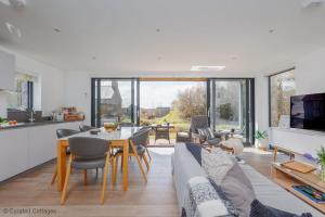a living room with a couch and a table at Little Spinney in Dorchester
