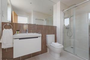 a bathroom with a toilet and a sink and a shower at Little Spinney in Dorchester +38 photos
