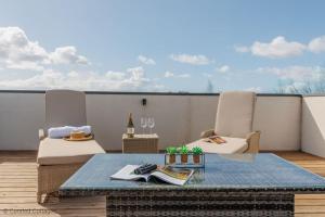 a patio with two chairs and a table on a balcony at Little Spinney in Dorchester
