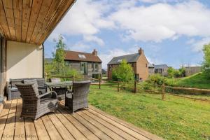 a wooden deck with a table and chairs on it at Little Spinney in Dorchester