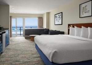 a hotel room with a bed and a living room at Starfish Manor Oceanfront Hotel in Lincoln City