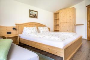 a bedroom with a large bed and wooden cabinets at Starbauer in Golling an der Salzach