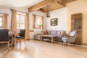 a living room with a couch and a table at Starbauer in Golling an der Salzach