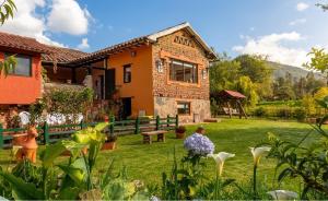 a house with a garden in front of it at Hotel la Mana Nobsa in Nobsa