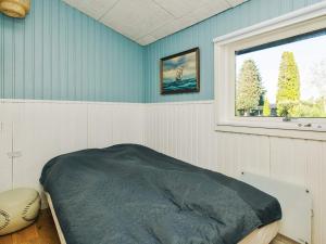a bed in a room with a window at 4 star holiday home in Slagelse in Slagelse