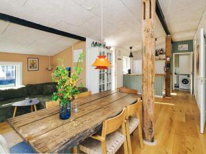 a large wooden table in a living room with a couch at 4 star holiday home in Slagelse in Slagelse