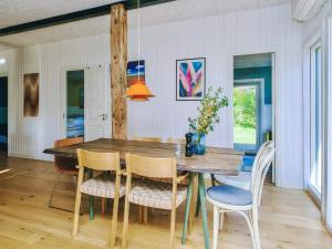 a dining room with a wooden table and chairs at 4 star holiday home in Slagelse in Slagelse +19 photos