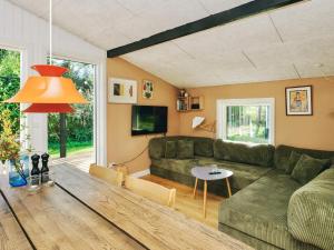 a living room with a couch and a table at 4 star holiday home in Slagelse in Slagelse