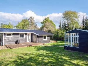 a house with a large yard in front of it at 4 star holiday home in Slagelse in Slagelse