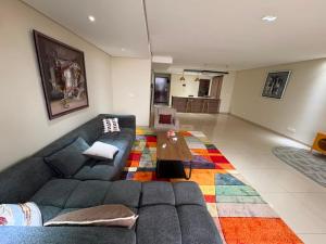 a living room with a couch and a coffee table at Waterfront - B luxury in Dakar