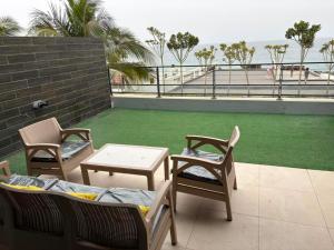 a patio with chairs and a table and a lawn at Waterfront - B luxury in Dakar +28 photos