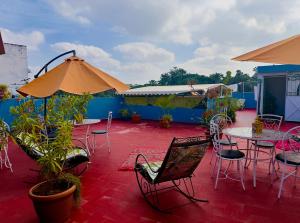 a patio with tables and chairs and umbrellas at Dar Rita in Rabat