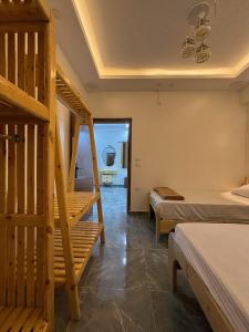 a room with two beds and a staircase in it at Villa solla in Dahab