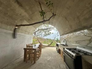 a kitchen with a table and a stove at Casa Lai in Mazunte