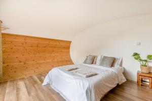 a bedroom with a bed with a wooden wall at 1 Bed in Bude oc-s34851 in Bude
