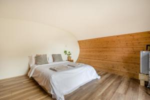 a bedroom with a white bed and a wooden wall at 1 Bed in Bude oc-s34851 in Bude