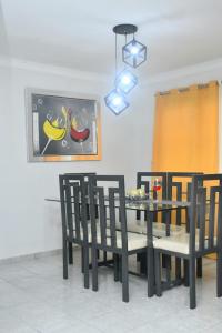 a dining room with a black table and chairs at Vacacional rent in Boca Chica