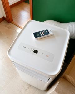 a remote control sitting on top of a white refrigerator at Appartement thème jungle in Avallon