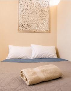 a bed with a blanket laying on top of it at Dalia Room, Paseo Durango in Durango