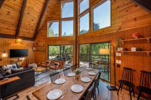 a dining room and living room with a long table at Hygge Haus Sequoia - Large Private Cabin w Views in Ponderosa