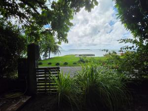 an open gate with a view of the ocean at Bora Bora Vairupe lodge in Bora Bora +8 photos