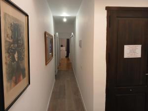 a hallway with two pictures on the walls and a door at Apartaments "Casa Melé" 2 in Lleida