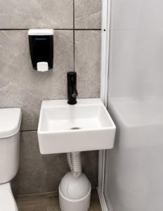 a bathroom with a sink and a toilet at Dalia Room, Paseo Durango in Durango