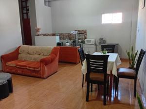 a living room with a couch and a table at Departamento ANSOPH in Ilo +12 photos