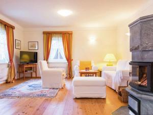 a living room with two beds and a fireplace at Almenblick in Kleblach