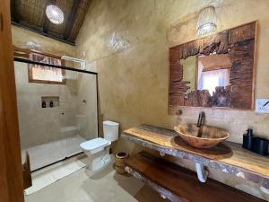 a bathroom with a sink and a toilet at Pousada Nitxi Awêry in Caraíva +39 photos