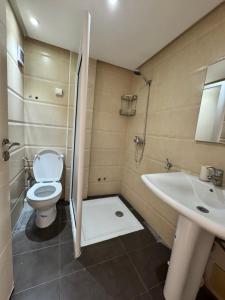 a bathroom with a toilet and a sink at Calma in Beni Mellal +23 photos