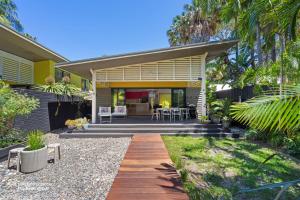 a home with a backyard with a wooden walkway at Bessou in Charlotte Bay