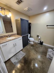 a bathroom with a toilet and a sink and a mirror at Just like home in Atlanta