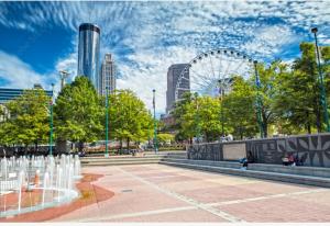 a park with a ferris wheel in a city at Just like home in Atlanta