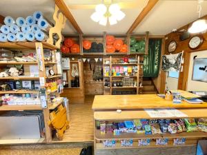 a shop with wooden shelves and a counter in a room at Camping field Kisokodo in Kiso-Fukushima