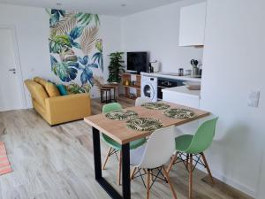 a kitchen and living room with a table and chairs at appartement F2 in Ferrel