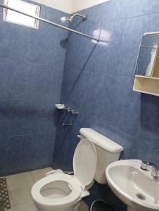 a bathroom with a toilet and a sink at LUCI Hospedaje in Uspallata +6 photos