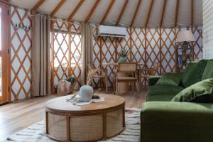 a yurt living room with a couch and a table at ETER Yurt Retreat in Stanišinci