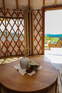 a wooden table with a bowl on top of a room at ETER Yurt Retreat in Stanišinci +19 photos